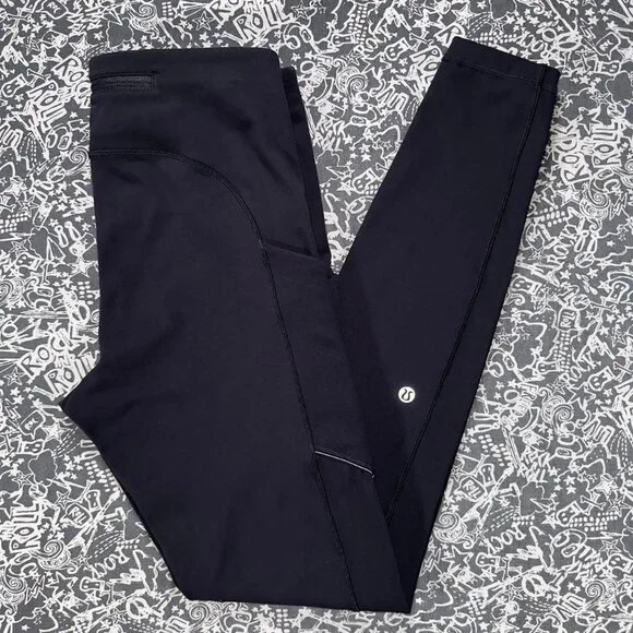 Black Lululemon leggings with mid-rise fit and side pockets - Picture 1 of 7